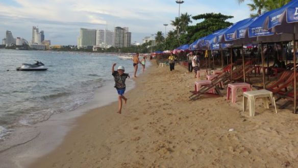 Oppu nauttii hiekasta ja aalloista -ja melkein tyhjästä rannasta